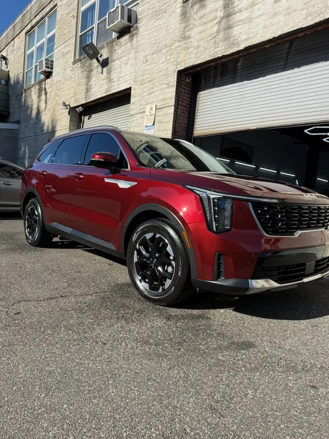 Red Kia SUV outside the shop - Shortstop Tint in Philadelphia, PA